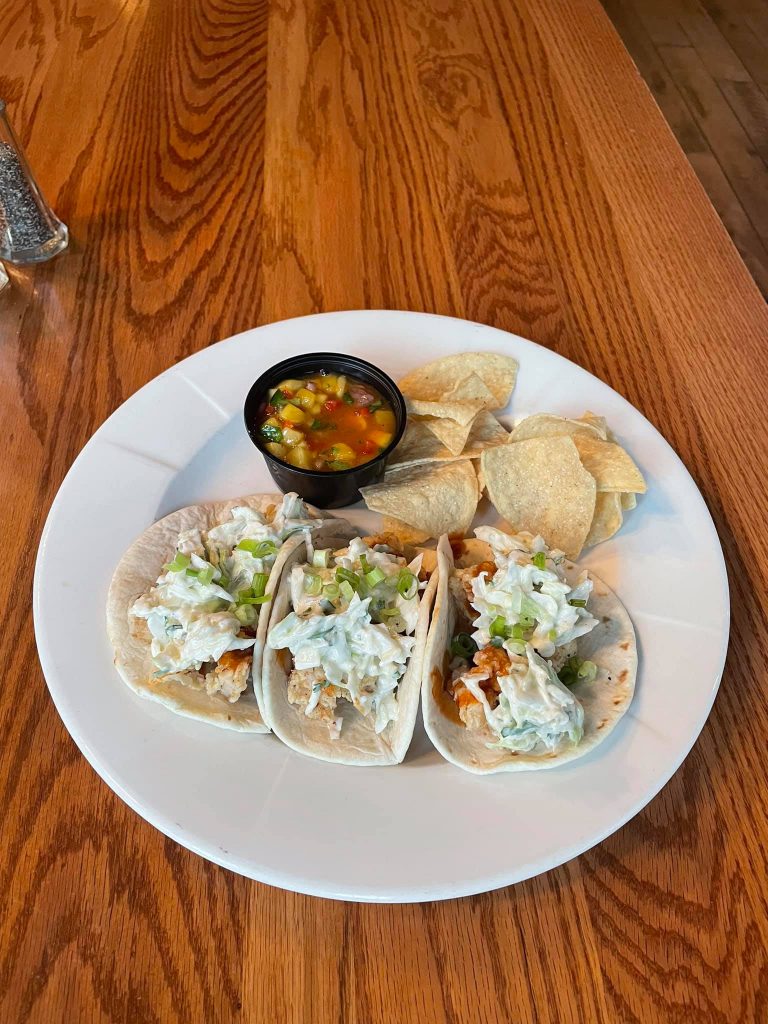 Plate of Alligator Tacos with chips and dip.