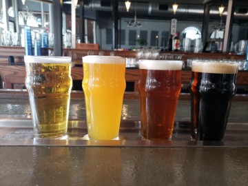 Selection of 4 beers on a bar at Fat Chad's Brewing.
