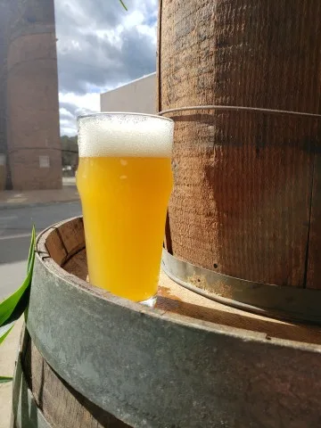 Glass of 2 Valves Beer on a barrel.