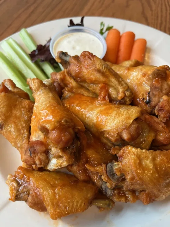 Chicken wings on a white plate.